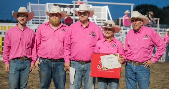 Logan Zeckser (far left) and Cindy Hinrichs, second from right, were awarded the Volunteer of the Year and the Committee Person of the Year, respectively, for their work with the Oregon Trail Rodeo in Hastings, Neb. Presenting the awards is, from left to right, Patrick Niles, Scott Hinrichs, and Dwight Dunsworth. Photo by Anita Burcham.  